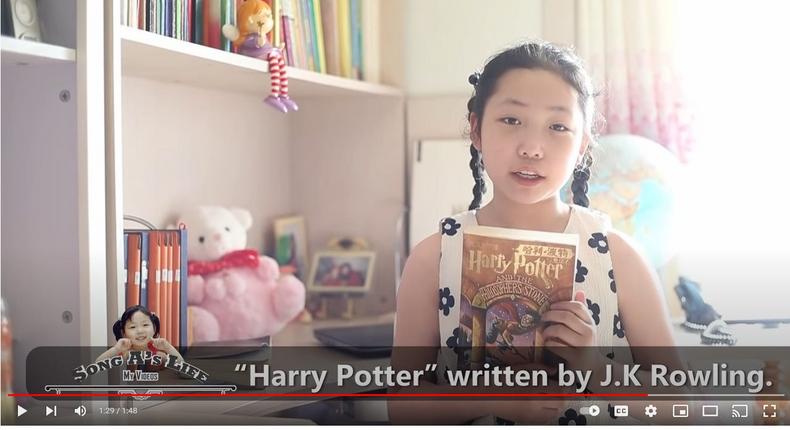 YouTuber Song A holds up a copy of Harry Potter and the Philosopher's Stone as she provides commentary in her first video.Screenshot/YouTube/Sally Parks  [ SongA Channel]