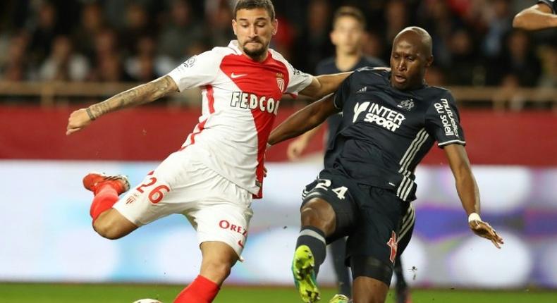 Monaco's Brazilian mildfielder Gabriel Boschilia (L) challenges Marseille's French defender Rod Fanni (R) during the French L1 football match between Monaco and Marseille at the Louis II Stadium in Monaco on November 26, 2016