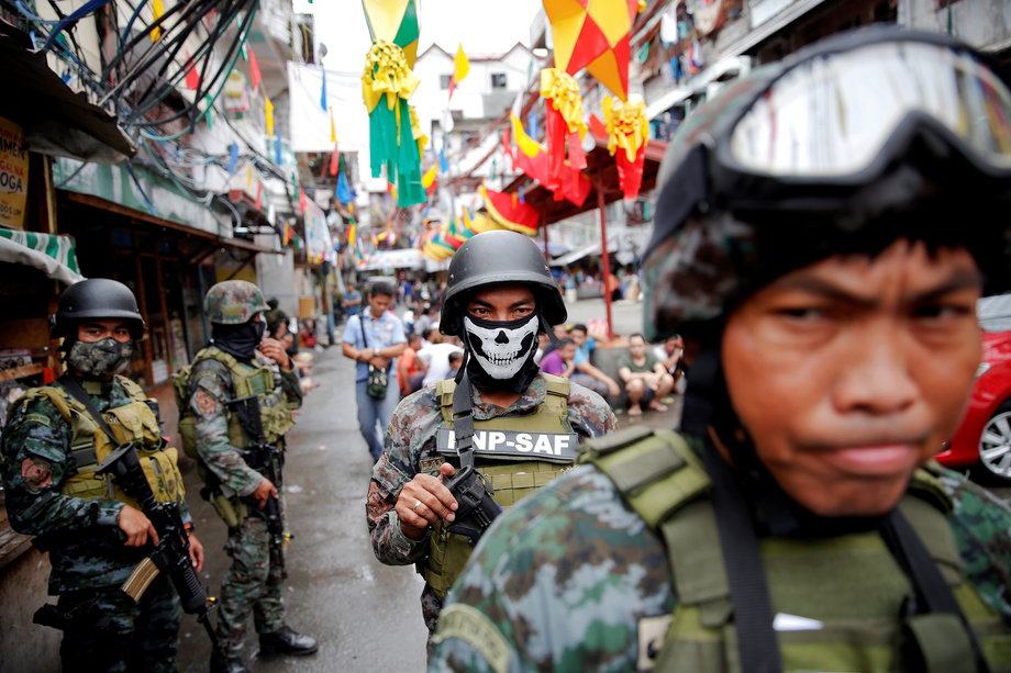 Armed security forces take a part in a drug raid, in Manila, Philippines, October 7, 2016.