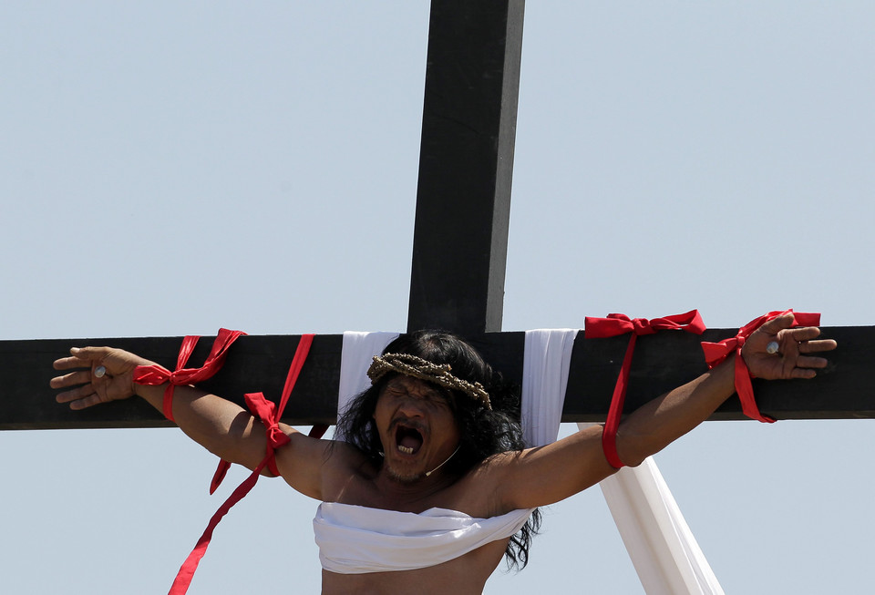 PHILIPPINES HOLY WEEK (Penitent is nailed to a wooden cross during the re-enactment of the crucifixion of Jesus Christ on Good Friday)