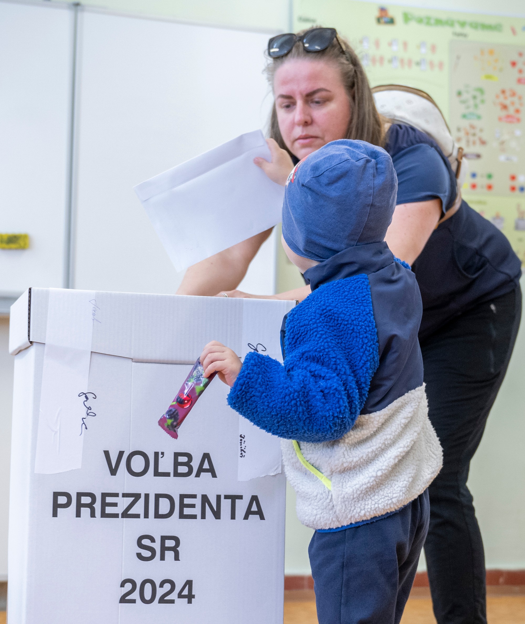 Chlapec vhadzuje obálku s hlasovacím lístkom do volebnej schránky v druhom kole prezidentských volieb v Senci.