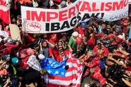 Various activists and Indigenous People's group burn a mock U.S. flag as they hold a rally supporting President Rodrigo Duterte's independent foreign policy in metro Manila