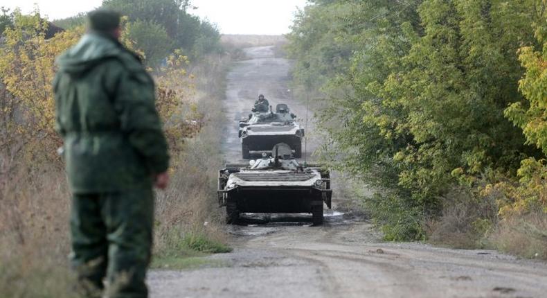 Pro-Russian separatists troops leave their position during withdrawal in the village of Petrovske, some 50 km from Donetsk, on October 3, 2016