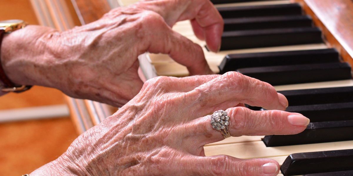 Ręce starszej kobiety na pianinie