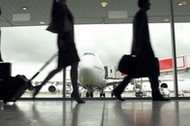 People walking through airport, silhouette (focus on aeroplane)