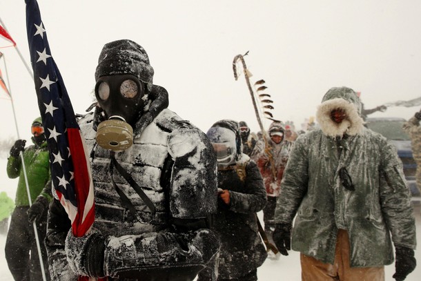 A man takes part in a march with veterans to Backwater Bridge just outside of the Oceti Sakowin camp