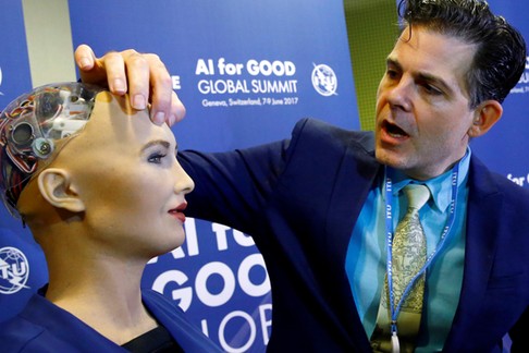 David Hanson of Hanson Robotics presents Sophia, a robot integrating the latest technologies and artificial intelligence is pictured during a presentation at the AI for Good Global Summit in Geneva