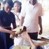 One of the two sacked female corps members returning her kits before being escorted out of the Ebonyi NYSC camp on Sunday, November 10, 2019.  (Punch)