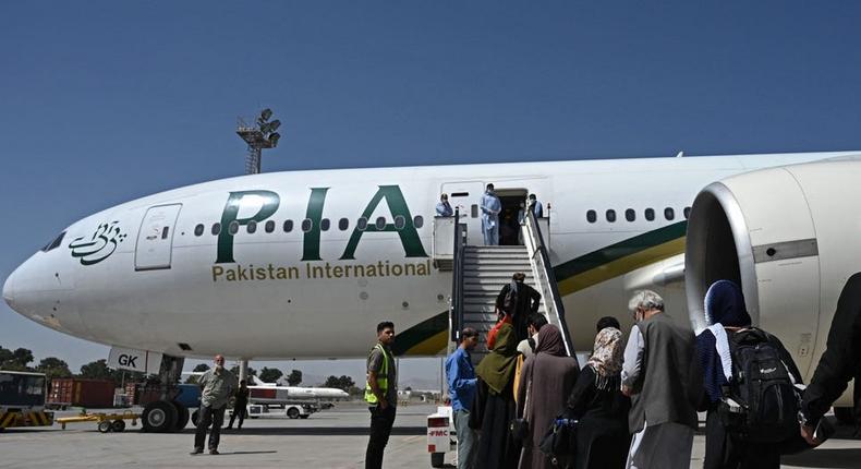 Passengers board a Pakistan International Airlines flight in Kabul
