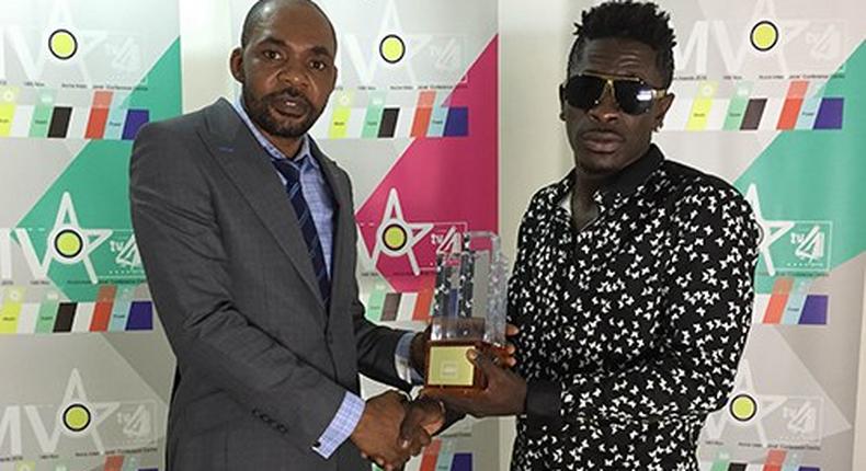 Shatta Wale receiving his 4syte Music Video award during the presentation.