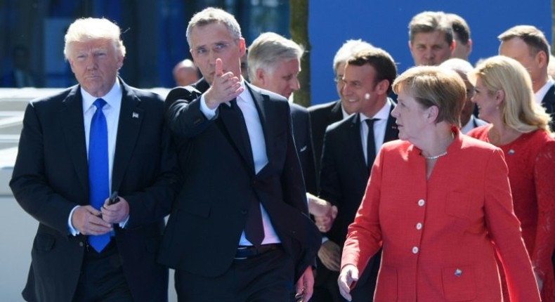 President Donald Trump, shown with NATO Secretary General Jens Stoltenberg (C) and German Chancellor Angela Merkel, has hit out at Germany over its car sales in the US, according to Der Spiegel