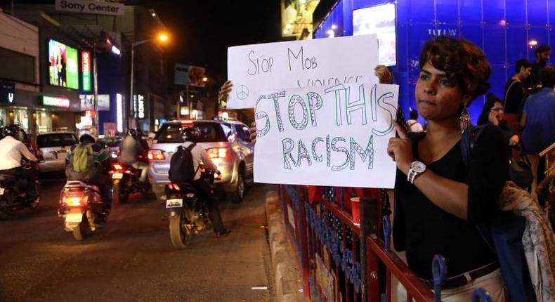 Indian women hold placards during a protest against the alleged molestation of a Tanzanian girl, in Bangalore.