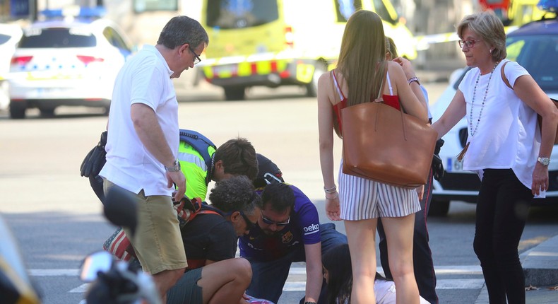 People attend to an injured woman following the van attack.