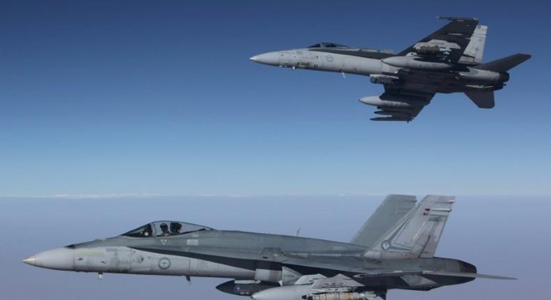 Royal Australian Air Force F/A-18A Hornets fly in formation after refuelling from a KC-30A on a mission over Syria. Australia has temporarily halted air missions following the shooting down of a Syrian jet by US forces