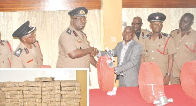 Mr Francis Owusu Ansah (in suit), CEO of Tohaba Limited, presenting the items to Dr Albert Brown Gaisie (4th left), Chief Fire Officer