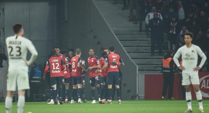 Paris Saint-Germain stand in stunned disbelief as Lille celebrate during their 5-1 win over the Ligue 1 leaders