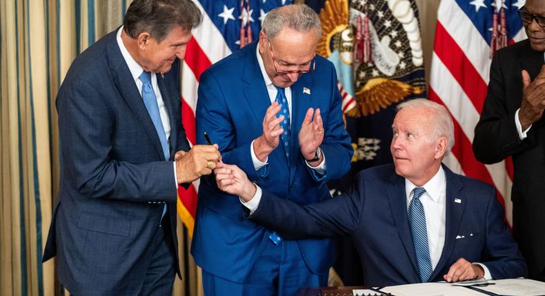 Joe Biden handed the pen used to sign the Inflation Reduction Act of 2022 into law to Sen. Joe Manchin.Kent Nishimura / Los Angeles Times via Getty Images