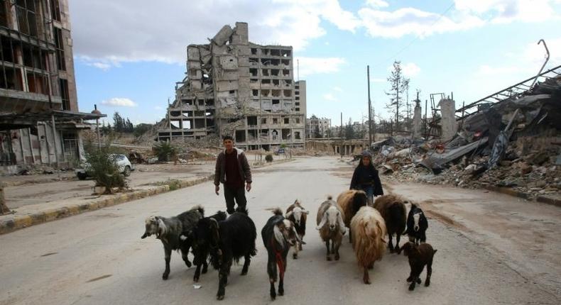 Syrian shepherds walk in the Shihan neighbourhood in the government-held side of Aleppo, on December 3, 2016