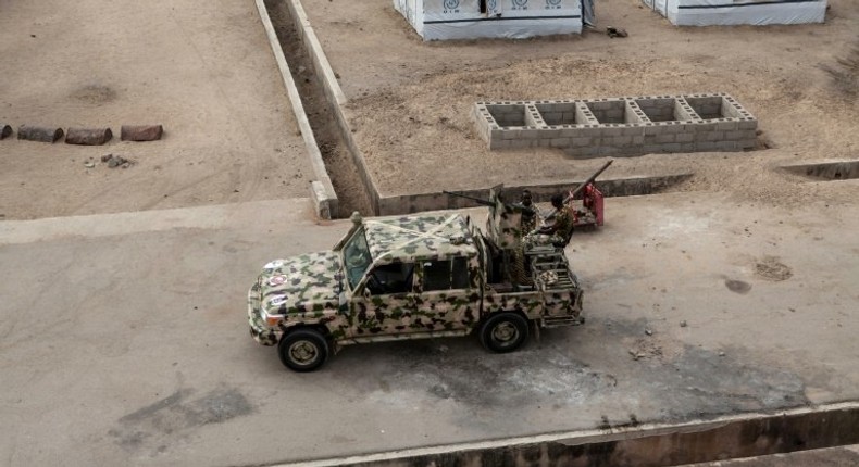 A Nigerian army vehicle patrols in the town of Banki in northeastern Nigeria in April last year. Troops say they have battled Boko Haram for years without relief.