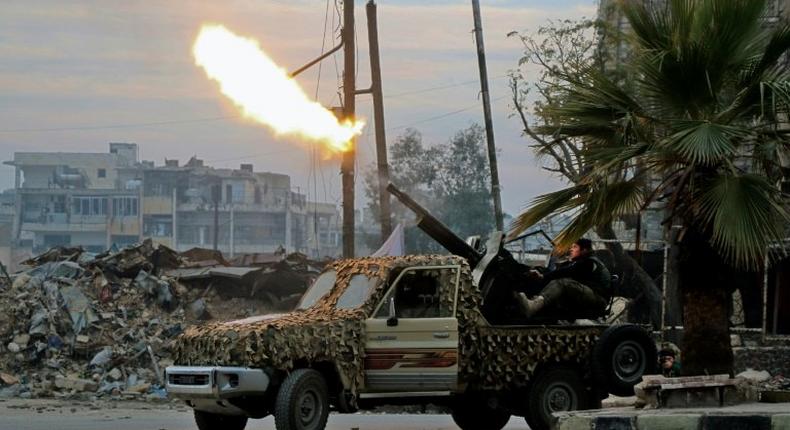 Fighters of the Free Syrian Army fire an anti-aircraft weapon in the rebel-held Mashhad area in southeastern Aleppo, on December 12, 2016