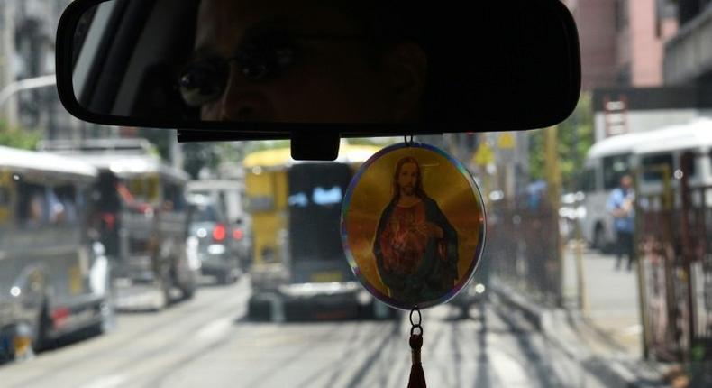 A Filipino taxi driver displays a religious icon inside his vehicle in Manila