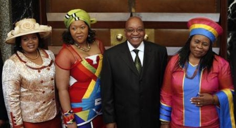 South African President Jacob Zuma poses for photographs with his three wives Sizakele Khumalo (R), Nompumelelo Ntuli (L) and Thobeka Mabhija after delivering his state-of-the-nation address in parliament in Cape Town.