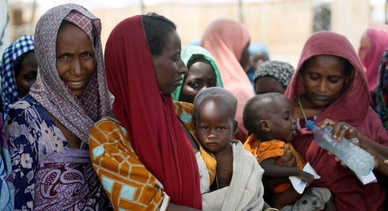 Women wait with their children under a shed for food rations at an internally displaced persons (IDP) camp on the outskirts of Maiduguri, northeast Nigeria June 6, 2017. 