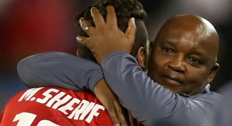 Al Ahly coach Pitso Mosimane (R) celebrates with star forward Mohamed Sherif (L) after the Egyptian club won the CAF Super Cup last May. Creator: -
