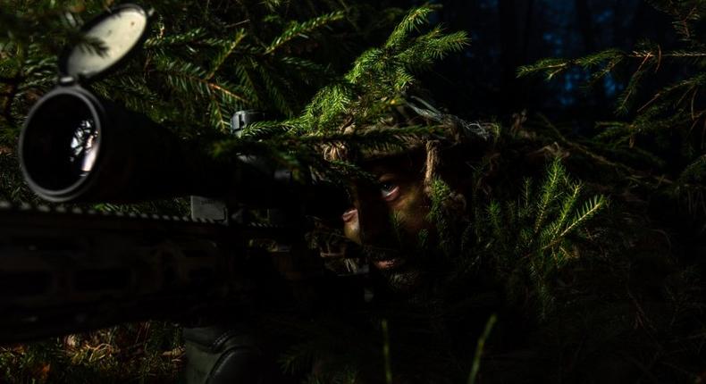 U.S. Army Sgt. John Stewart, an American Sniper assigned to NATOs Battle Group Poland, improves his fighting position during react to contact drills at Bemowo Piskie Training Area, Poland, Nov. 8, 2018.