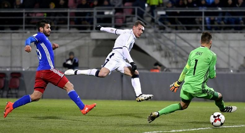 Italy's forward Andrea Belotti (C) scores past Liechtenstein's defender Michele Polverino (L) and goalkeeper Peter Jehle on November 12, 2016