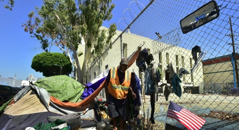 Homeless veteran Kendrick Bailey steps out of his tent on a streetcorner near Skid Row in downtown Los Angeles