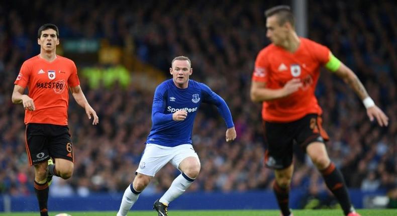 Everton's English striker Wayne Rooney (C) prepares to challenge MFK Ruzomberok's Kristi Qose (L) during the UEFA Europa League third qualifying round, Game 1 match July 27, 2017