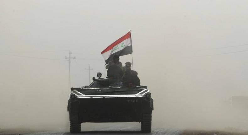 Iraqi forces enter the village of Abu Shuwayhah, south of Mosul, on November 1, 2016
