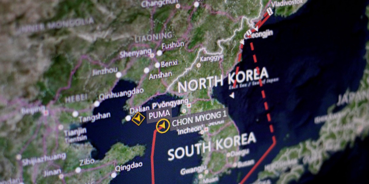 A ship-tracking screen shows one vessel's movement from Vladivostok, Russia, to Nanpo, North Korea.