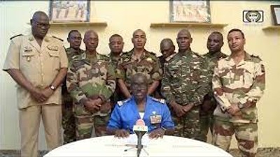 Niger Army spokesman Col. Major Amadou Adramane speaks during an appearance on national television after President Mohamed Bazoum was held in the presidential palace, in Niamey, Niger, July 26, 2023, in this still image taken from video. (ORTN/via Reuters TV/Handout via REUTERS)