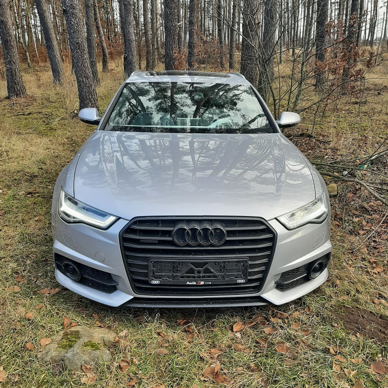 Luksusowe Audi z włączonym silnikiem porzucone w lesie