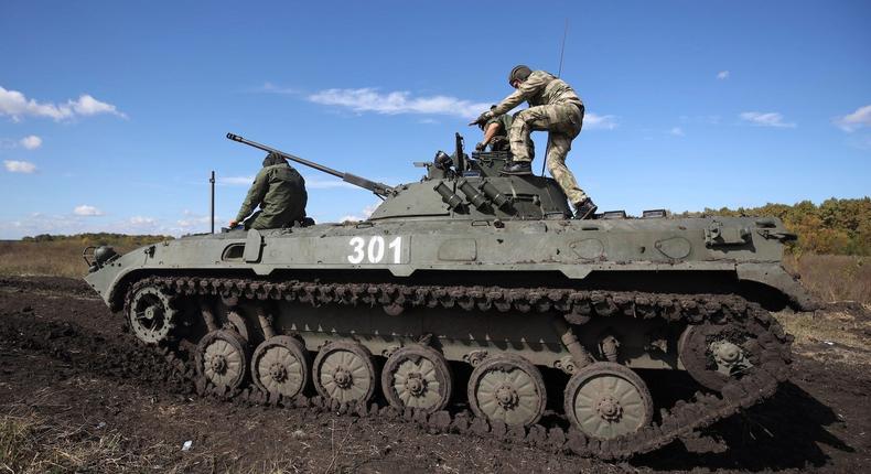 Recruits drive an armored vehicle during a military training at a firing range in the Krasnodar region in southern Russia.AP Photo