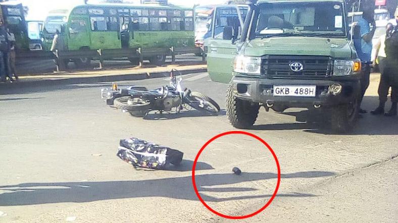 Scene after suspects abandoned Motorcycle and shopping bag with explosives. Grenade (circled) that was hurled at police 