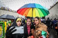 An Iranian woman take selfies during a ceremony to mark the 40th anniversary of the Islamic Revoluti