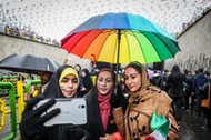 An Iranian woman take selfies during a ceremony to mark the 40th anniversary of the Islamic Revoluti