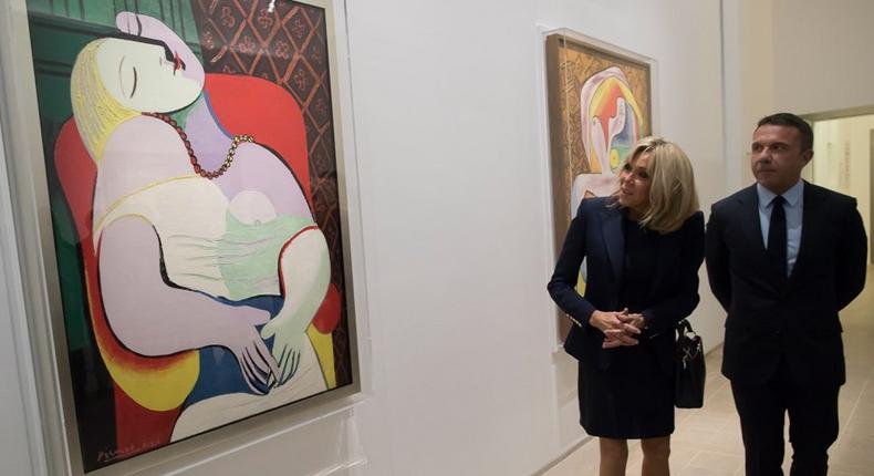 Wife of French President Emmanuel Macron, Brigitte looks at paintings by Spanish painter Pablo Picasso flanked by the painter's grandson Olivier as they visit the