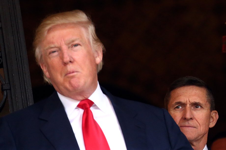 U.S. Army Lieutenant General Michael Flynn looks at U.S. President-elect Donald Trump as he talks with the media at Mar-a-Lago estate where Trump attends meetings, in Palm Beach, Florida, U.S., December 21, 2016.