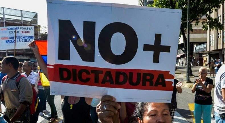 A Venezuelan activist chants slogans against President Nicolas Maduro during an opposition rally in Caracas, on March 31, 2017