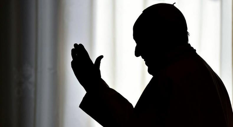 Pope Francis is silhouetted on March 24, 2017 at the Vatican