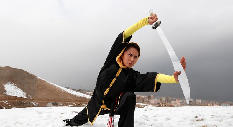 Sima Azimi, 20, a trainer at the Shaolin Wushu club, shows her Wushu skills to other students.