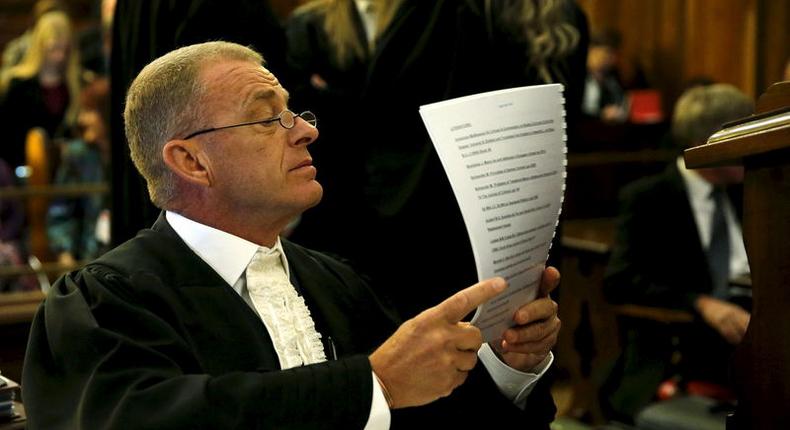 Prosecutor Gerrie Nel reads a document before an appeal by state prosecutors against South African paralympian Oscar Pistorius's conviction last year at the Supreme Court of Appeal (SCA) in Bloemfontein, November 3, 2015. REUTERS/Siphiwe Sibeko