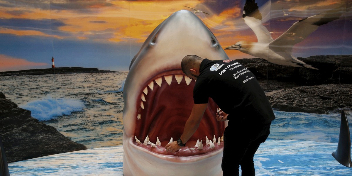 A man checks a shark display at the Dubai Mall, UAE.