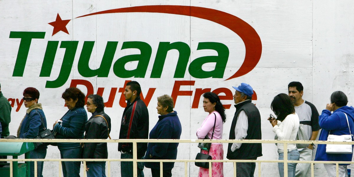 People wait in line to cross the border between Mexico and the US in Tijuana, Mexico, May 6, 2006.