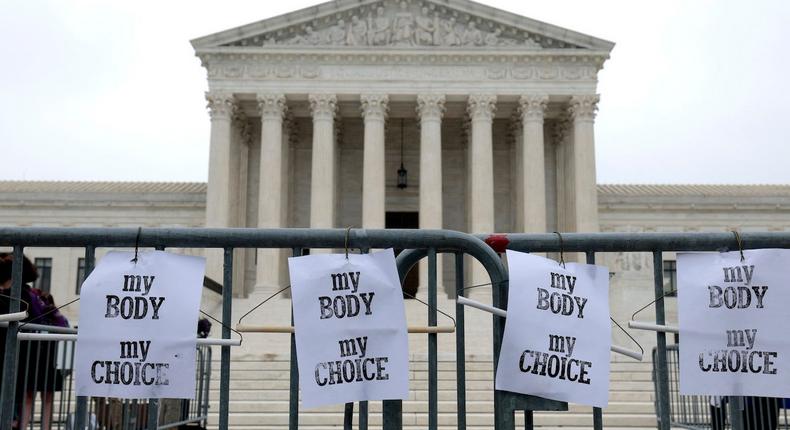 Pro-choice signs hang on a police barricade at the U.S. Supreme Court Building in Washington, DC, on May 3, 2022.