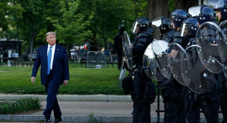 President Donald Trump walks past police in Lafayette Park after visiting outside St. John's Church across from the White House Monday, June 1, 2020, in Washington. Part of the church was set on fire during protests on Sunday night. (AP Photo/Patrick Semansky)